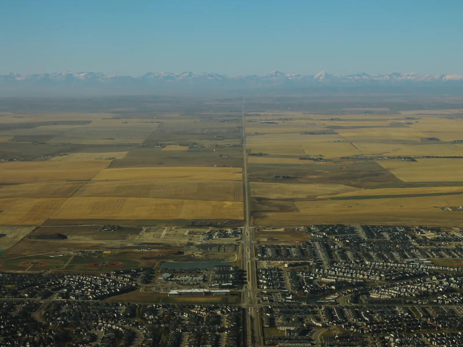 Airdrie, AB — aerial view toward the Rocky Mountains